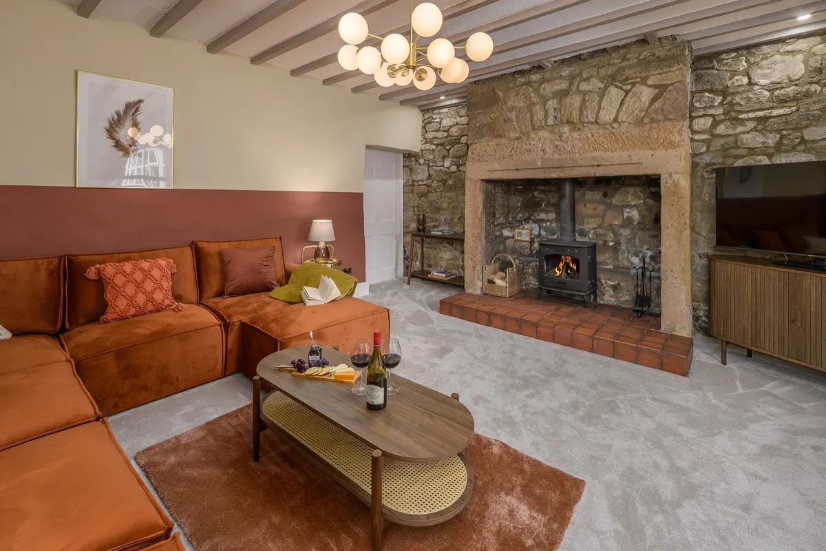 Living room with a corner sofa and stone fireplace