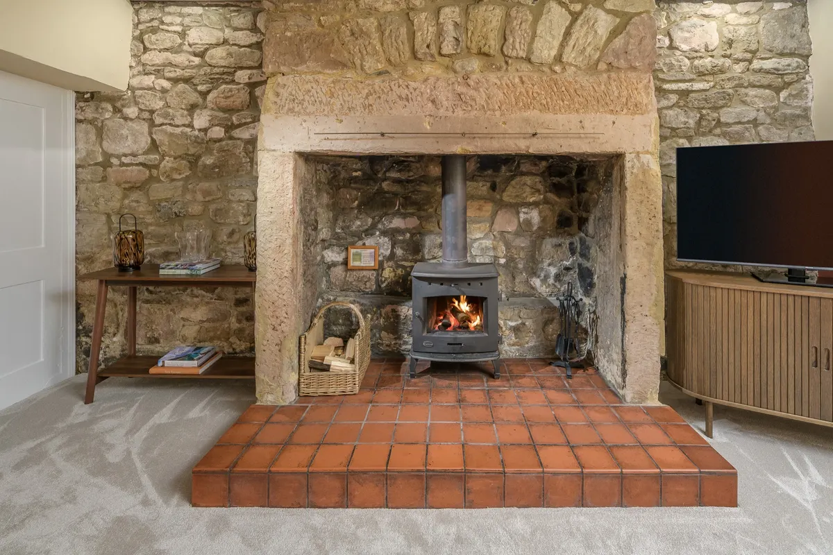 Wood burner in the living room stone fireplace